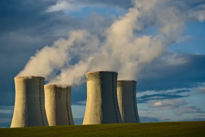 gray concrete towers under white clouds and blue sky during daytime